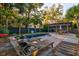 Spacious backyard pool featuring a hot tub, outdoor seating, palm trees, and a charming covered pergola at 731 Fort Johnson Rd, Charleston, SC 29412