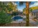 Private backyard featuring an in-ground pool, patio furniture and mature tropical landscaping at 731 Fort Johnson Rd, Charleston, SC 29412