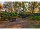 Enjoy the tranquil backyard space with gravel, mature landscaping, and comfortable seating at 731 Fort Johnson Rd, Charleston, SC 29412