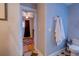 Bright bathroom featuring a toilet, towel rack, and view of a zebra-print bedroom at 731 Fort Johnson Rd, Charleston, SC 29412