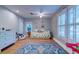Spacious bedroom with hardwood floors, bright windows, a ceiling fan and colorful decorations at 731 Fort Johnson Rd, Charleston, SC 29412
