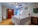 Comfortable bedroom with hardwood floors, ceiling fan, wooden armoire and stylish decor at 731 Fort Johnson Rd, Charleston, SC 29412