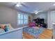 Bright bedroom with hardwood floors, ceiling fans, toys and a bookshelf for storage at 731 Fort Johnson Rd, Charleston, SC 29412