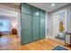 Hallway with light wood floors and green storage cabinets leading to bedroom and bathroom at 731 Fort Johnson Rd, Charleston, SC 29412