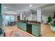 Well-appointed kitchen featuring custom cabinetry, hardwood floors, and an open layout to the living and dining rooms at 731 Fort Johnson Rd, Charleston, SC 29412