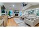 Bright and airy living room with stone fireplace, hardwood floors, vaulted ceilings, and open to the kitchen at 731 Fort Johnson Rd, Charleston, SC 29412