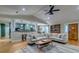 Open concept living room with hardwood floors, neutral sectional and connected eat-in kitchen at 731 Fort Johnson Rd, Charleston, SC 29412