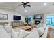 Cozy living room with hardwood floors, neutral sectional, stone fireplace, and decor at 731 Fort Johnson Rd, Charleston, SC 29412