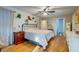 Bright main bedroom featuring hardwood floors, ceiling fan and ensuite bathroom and office area at 731 Fort Johnson Rd, Charleston, SC 29412
