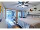 Spacious main bedroom with hardwood floors, shiplap accent wall and ensuite bathroom and sunroom at 731 Fort Johnson Rd, Charleston, SC 29412
