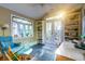 Cozy office area with stained glass windows, built-in shelving, and French doors to the back yard at 731 Fort Johnson Rd, Charleston, SC 29412