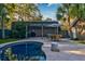 Inviting backyard pool area with a pergola, outdoor seating, and mature landscaping at 731 Fort Johnson Rd, Charleston, SC 29412