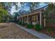 Charming front porch featuring a swing, comfortable seating, and view of the well-maintained front yard at 731 Fort Johnson Rd, Charleston, SC 29412