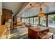 Bright sunroom features a chandelier, dining table, and casual seating with views of the pool at 731 Fort Johnson Rd, Charleston, SC 29412