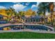 Inviting backyard with a private pool, lounge chair, an umbrella shaded dining table, and mature palm trees at 731 Fort Johnson Rd, Charleston, SC 29412
