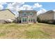 View of the home's backyard with a patio and a lawn extending to the fence in a residential area at 7753 Kinston St, North Charleston, SC 29418