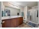 A well-lit bathroom features dual sinks, a large mirror, and a glass-enclosed shower at 7753 Kinston St, North Charleston, SC 29418