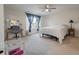 A cozy bedroom with a neutral color palette, large windows with blinds, and carpet flooring at 7753 Kinston St, North Charleston, SC 29418