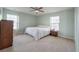 Bright bedroom featuring carpet flooring, neutral paint, and natural light from two windows at 7753 Kinston St, North Charleston, SC 29418