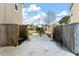 Spacious driveway, enclosed by wood fence, leads to backyard and provides ample parking space at 7753 Kinston St, North Charleston, SC 29418