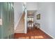 Bright foyer with hardwood floors, staircase, and open view to the living room at 7753 Kinston St, North Charleston, SC 29418