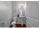 Cozy half-bathroom with a pedestal sink, oval mirror, and neutral decor at 7753 Kinston St, North Charleston, SC 29418