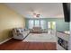 Inviting living room featuring comfortable seating and a ceiling fan for a relaxing atmosphere at 7753 Kinston St, North Charleston, SC 29418
