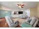 Open-concept living room featuring hardwood floors, ceiling fan, and natural light at 7753 Kinston St, North Charleston, SC 29418