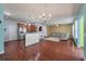 Open-concept living space with hardwood floors and a view of the kitchen and dining area at 7753 Kinston St, North Charleston, SC 29418