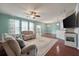 Spacious living room with hardwood floors, ceiling fan, and a large window at 7753 Kinston St, North Charleston, SC 29418
