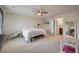 A spacious bedroom featuring carpet flooring, ceiling fan and an ensuite bathroom at 7753 Kinston St, North Charleston, SC 29418