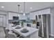 Modern kitchen featuring a large island with seating, stainless steel appliances, and stylish backsplash at 828 Longbranch Dr, Charleston, SC 29414