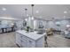 Open-concept kitchen with island seating seamlessly connecting to dining and living areas at 828 Longbranch Dr, Charleston, SC 29414
