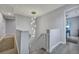 Bright staircase features a modern chandelier and light gray paint at 828 Longbranch Dr, Charleston, SC 29414