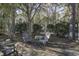 Relaxing backyard featuring Adirondack chairs and a cozy outdoor seating area amidst lush greenery at 901 Elm Hall Cir, Summerville, SC 29483