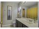 Well-lit bathroom featuring a modern vanity, decorative mirror, and stylish shower curtain at 901 Elm Hall Cir, Summerville, SC 29483