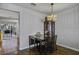 Cozy dining area featuring hardwood floors and an elegant chandelier over a dining table at 901 Elm Hall Cir, Summerville, SC 29483