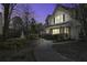 Exterior of well maintained townhouse at dusk overlooking a pond with fountain at 901 Elm Hall Cir, Summerville, SC 29483