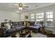 Comfortable living room features a large sectional sofa and natural light from bright windows at 901 Elm Hall Cir, Summerville, SC 29483