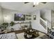 Cozy living room features a large TV, comfortable seating, and decor shelves at 901 Elm Hall Cir, Summerville, SC 29483