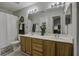 Bright bathroom featuring double vanity sinks, a large mirror, and a shower-tub combo at 901 Elm Hall Cir, Summerville, SC 29483