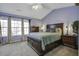 Comfortable main bedroom with ample natural light, complemented by a king-size bed and carpeted floors at 901 Elm Hall Cir, Summerville, SC 29483