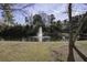 Scenic view of the community pond featuring a water fountain and surrounding trees at 901 Elm Hall Cir, Summerville, SC 29483