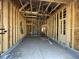 Living room under construction featuring wood framing, wiring, and door to the rear at 909 Dusk Dr, Summerville, SC 29486