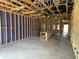 Open-concept living room under construction with wood framing, insulation, and concrete flooring at 909 Dusk Dr, Summerville, SC 29486