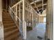 New home staircase under construction with wood framing and temporary railings at 909 Dusk Dr, Summerville, SC 29486