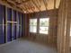 Interior view of new home construction in progress showing window framing and purple sheathing at 911 Dusk Dr, Summerville, SC 29486