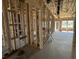 Living area in new construction with exposed wood framing, concrete floors, and natural light at 911 Dusk Dr, Summerville, SC 29486