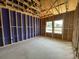 Living area in new home construction with exposed wood framing and natural light from windows at 911 Dusk Dr, Summerville, SC 29486