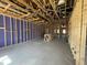 Spacious room in new home construction with exposed wood framing and concrete flooring at 911 Dusk Dr, Summerville, SC 29486
